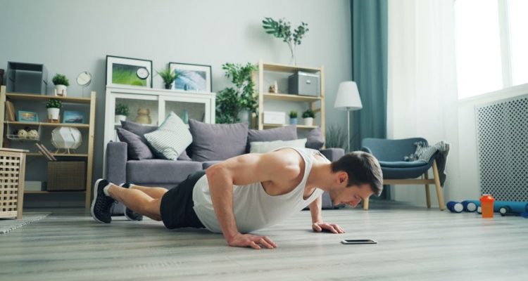 a man is doing push ups on the floor